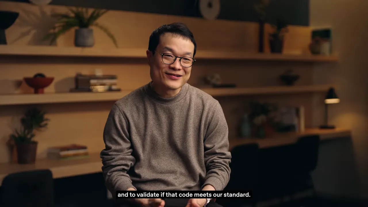 ผู้เชี่ยวชาญของ Rakuten พูดถึงการยืนยันว่าโค้ดเป็นไปตามมาตรฐาน โดยมีคำบรรยาย 'and to validate if that code meets our standard.'